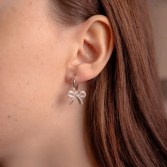 Silver Bow Huggie Earrings